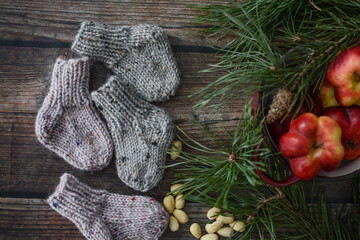 Chunky and warm baby socks o dark wooden background