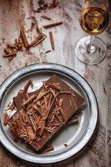 A glass of cognac, brandy or whiskey and grated pieces of chocolate bar