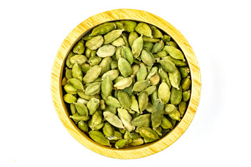 Spice Green Cardamom in wooden bowl isolated on white background