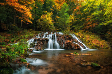 Fototapeta na wymiar Beautiful waterfall Dokuzak in Strandzha Mountain, Bulgaria at autumn. Waterfall in the forest. Green forest landscape near Bourgas