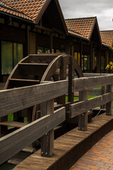 wooden bridge over the river with a mill