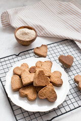 homemade heart-shaped cookies cool on the grill, valentine's day gift with love, gluten-free buckwheat flour pastries.