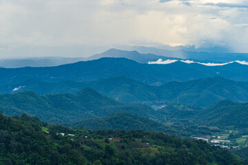 Fototapeta na wymiar Mountains range in northern Thailand in the rainy season where the rain is falling into the forest.