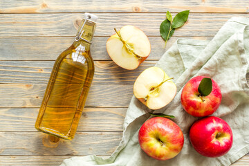Bottle of organic apple cider vinegar with red apples