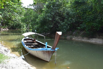traditional long tail boat in canal at Rachayai island phuket Thailand.ecology of brackish water.