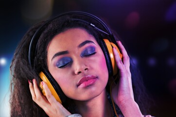 Stylish fashion teenager model wearing headphones listening to dj music