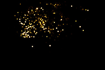 Golden blurred bokeh lights on black background. Glitter sparkle stars for celebrate. Overlay for...