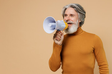 Elderly gray-haired mustache bearded man 50s in mustard yellow turtleneck shirt hold scream in...