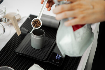 Fototapeta na wymiar Put the coffee beans in the coffee grinder. For making coffee in the morning