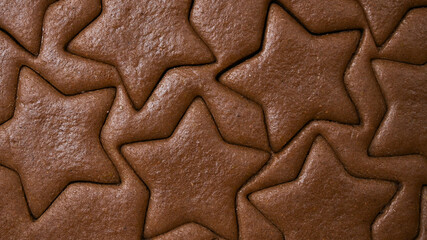 Gingerbread dough for christmas cookies texture with star shapes. Baking concept.