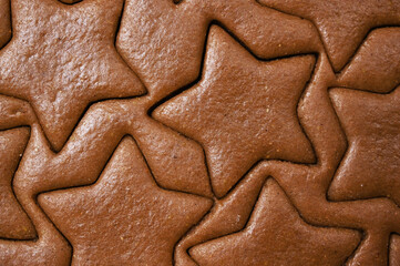 Closeup of Gingerbread dough for christmas cookies texture with star shapes