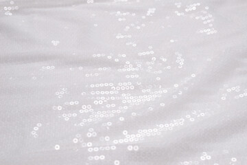 White sequin background. White shiny sequin fabric.