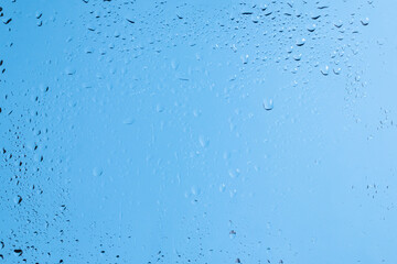 Blue backgrond with water drops. Wet glass.