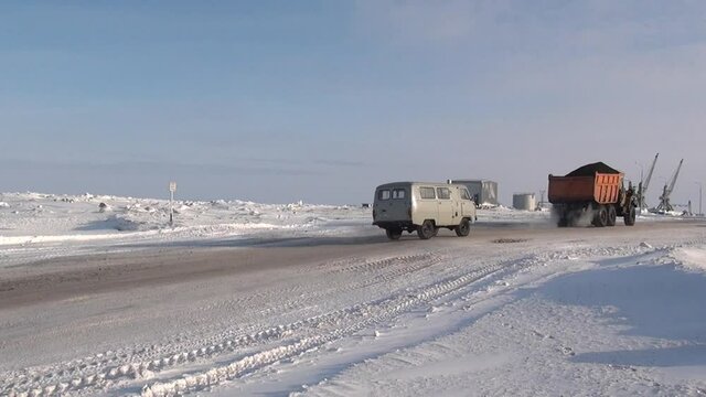 Chukotka, Russia. - 13 April 2013: Snow-removing machine cleans road in Anadyr city on far north. Cold snow town on edge of earth.