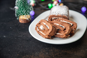 christmas cake roll chocolate white cream ready to eat meal snack on the table copy space food background rustic. top view