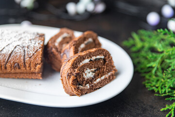 christmas cake roll chocolate white cream ready to eat meal snack on the table copy space food background rustic. top view