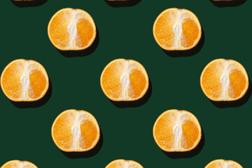 Pattern from a cut orange on a green background.