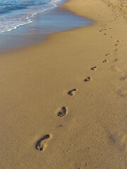 Human footprints on the coastline of a resort