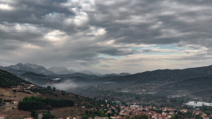 Fototapeta na wymiar Morning fog over a Greek mountain village