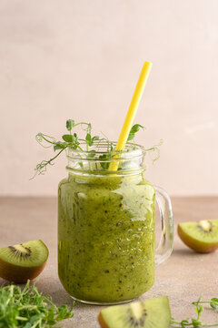 Green smoothie made from kiwi and pea sprouts.