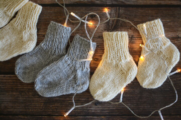 Chunky and warm handmade woolen socks on dark wooden background 