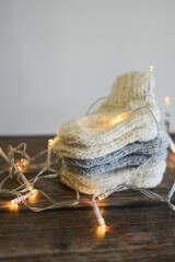 Chunky and warm handmade woolen socks on dark wooden background 
