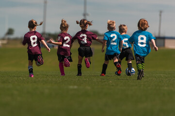 Young Children Kids Outside Playing Soccer Sport Running Together Team Numbers Boys Girls Fit Healthy Lifestyle 