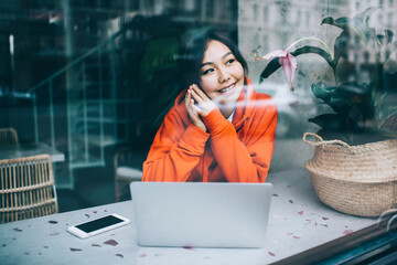Positive Asian woman with clasped hands