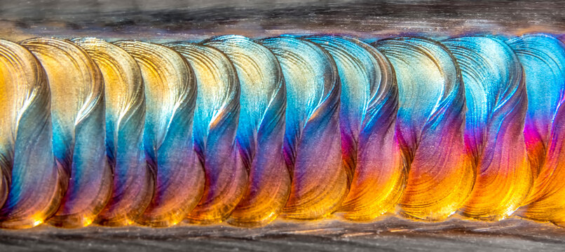 Welding of stainless steel with argon arc welding. Welding TIG. Color welding seam.