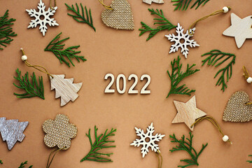 Fototapeta na wymiar the new year is coming. wooden numbers 2022. Christmas decorations made of eco-friendly materials. toys made of wood, paper, cardboard.