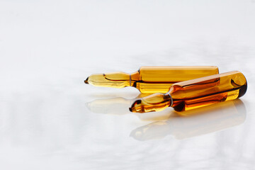 Glass ampoules with medicine or chemical reagent on the table. Medical ampoules close-up. Beauty...
