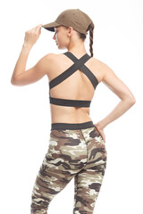 Girl in a baseball cap and camouflage top on a white background. Attractive white Caucasian girl in clothes for sport and fitness.