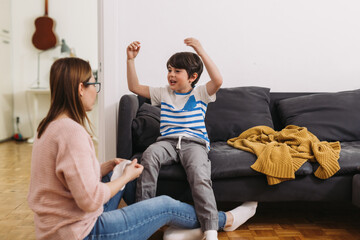 mother helping her child to put on socks