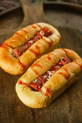 Delicious fresh homemade bread pizza and sausage with hot chili sauce and mayonnaise, on a wooden.