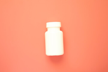 White pill bottle mockup on pink color background