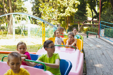 Fototapeta na wymiar The happy little children are resting in the amusement park