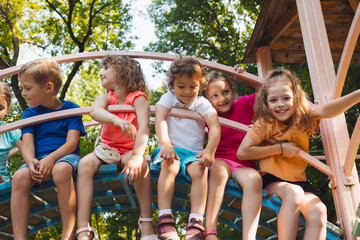 The cute kids are resting in the playground in summer - 466536460