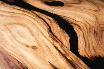 Style wooden countertop slab, saw cut wood treated with varnish close-up on black. Isolate.