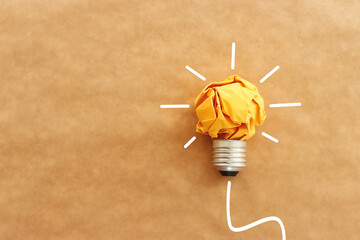 Concept image of crumpled paper lightbulb, symbol of scr, innovation and eco friendly business