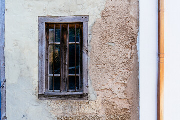 Facade of a house in the country with an old blue wooden window.