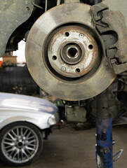 Disc brake of the vehicle for repair. Car brake repairing in garage.Suspension of car for...