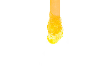 sugar for depilation on a stick on an isolated white background.
