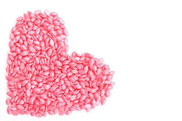 pink wax for depilation in granules, in the shape of a heart