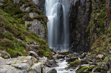 Wailing Widow Falls in Assynt, North West Highlands of Scotland. Falls with smoothed water, stream, rocks, cliffs either side with greenery. No people.