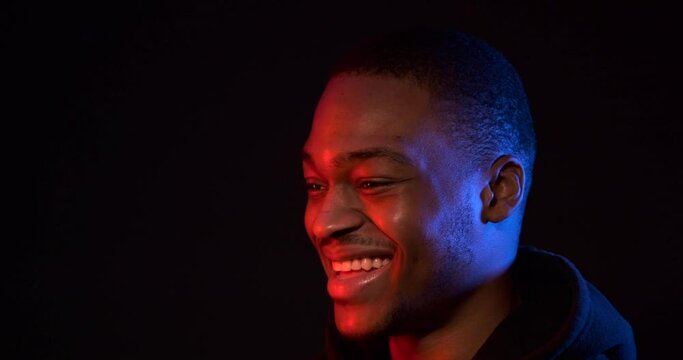 Neon light profile of happy african american man in hoodie