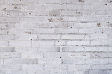 Abstract background is a light-colored brick surface with space for copying.