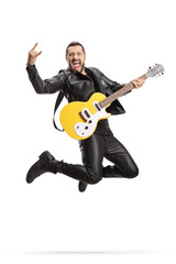 Male rock musician with an electric guitar jumping