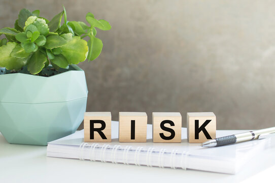 the word risk, spelt on wooden cubes with letters over on the table