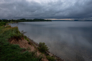 Landscape with the coast of Lake Razna in calm clear weather . Surface of the clean freshwater Latvian Lake Razna on summer morning