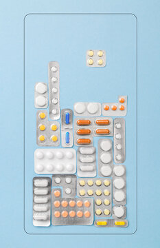 Block game from medical pills, top view on blue background. Health care concept as a challenge or quest. Treatment blisters of tablets in shape of tetris game. Healthcare pharmaceutical background